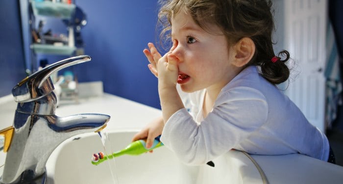 toddler brushing teeth.