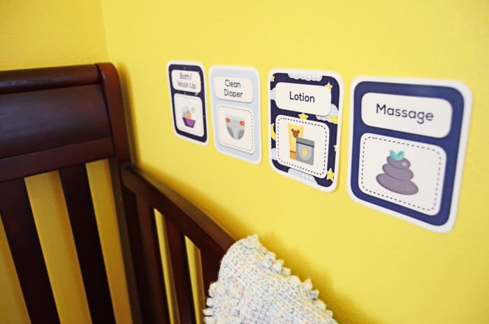 Printed routine cards on baby room wall. 