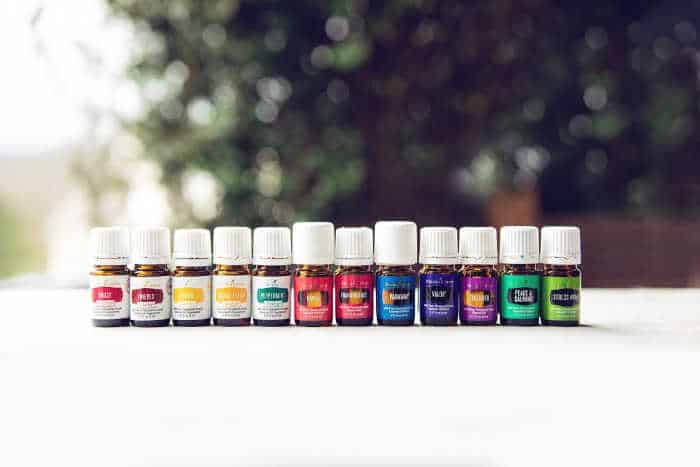 12 young living essential oils in 5 ml bottles lined up neatly in a row. many of the oils inside the young living premium starter kit are excellent essential oils for stress. 
