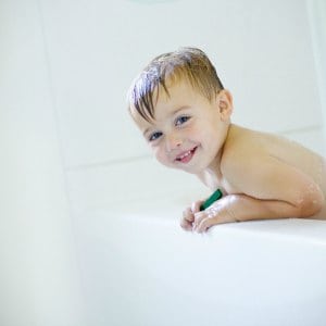 kid smiling in the bathtub
