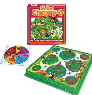 Game board with flat trees and plastic cherries on the tree. Game spinner.