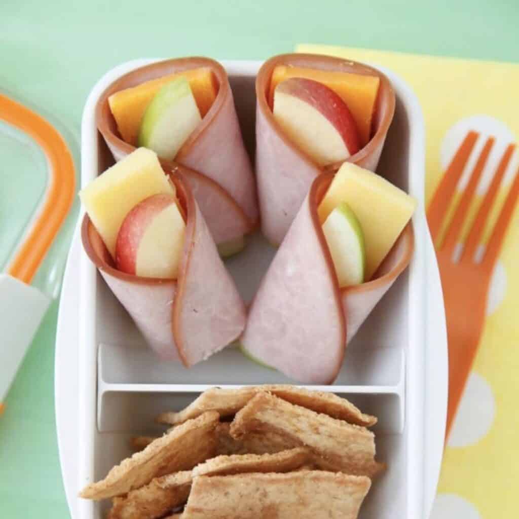 Slice of apple and cheese wrapped in lunchmeat ham