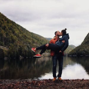 couple kissing near mountains